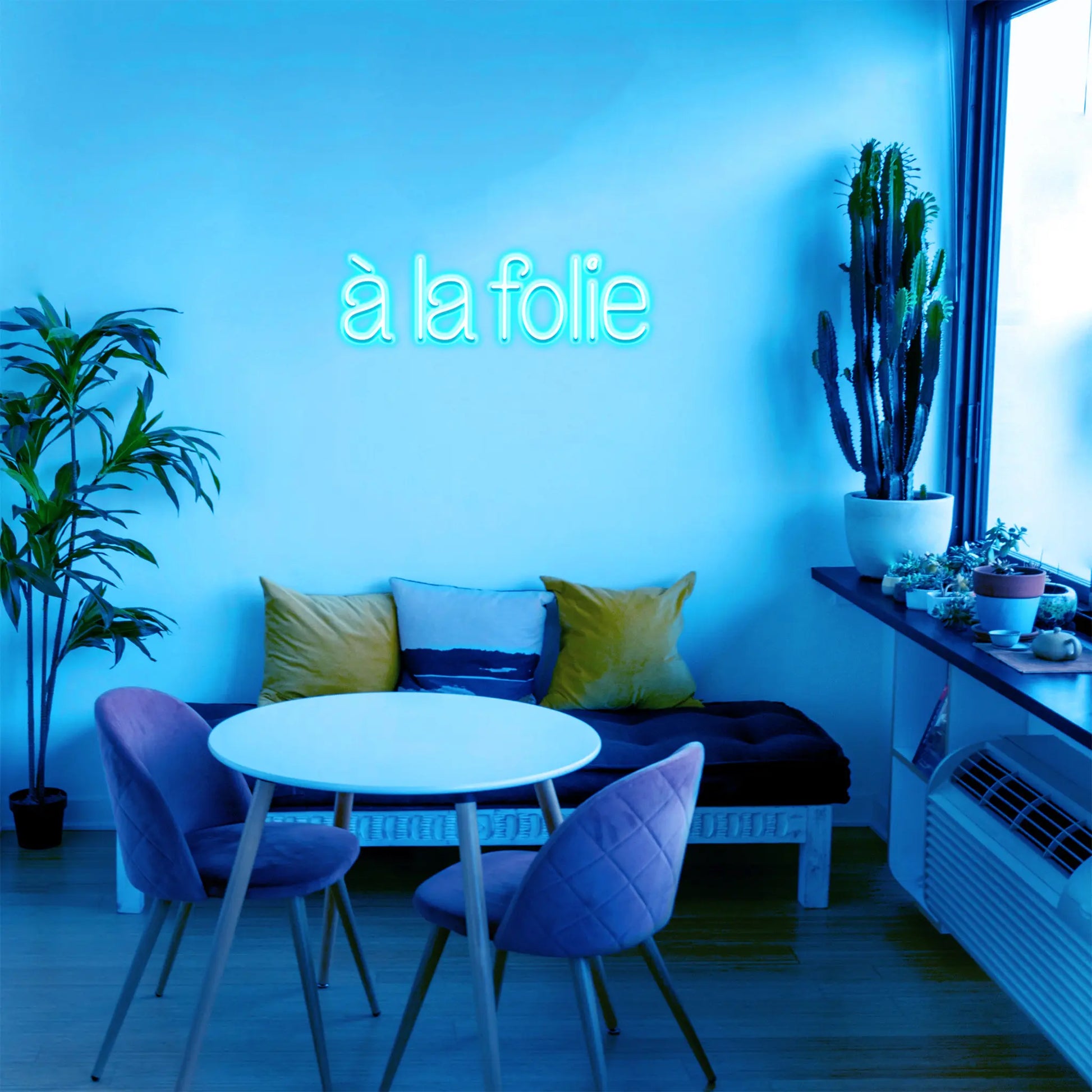 À la Folie Neon Sign glowing in bold neon lights, perfect for setting a passionate, lively mood in any room.