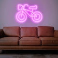 Glow Cycle Neon Light lit up with bright neon colors, bringing a sense of action and excitement to any room.