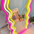 Wavy Neon Mirror brightening up a hallway with soft neon light.
