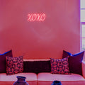 Close-up view of the XOXO neon sign, showcasing vibrant pink and white neon lights, perfect for home or office decor.